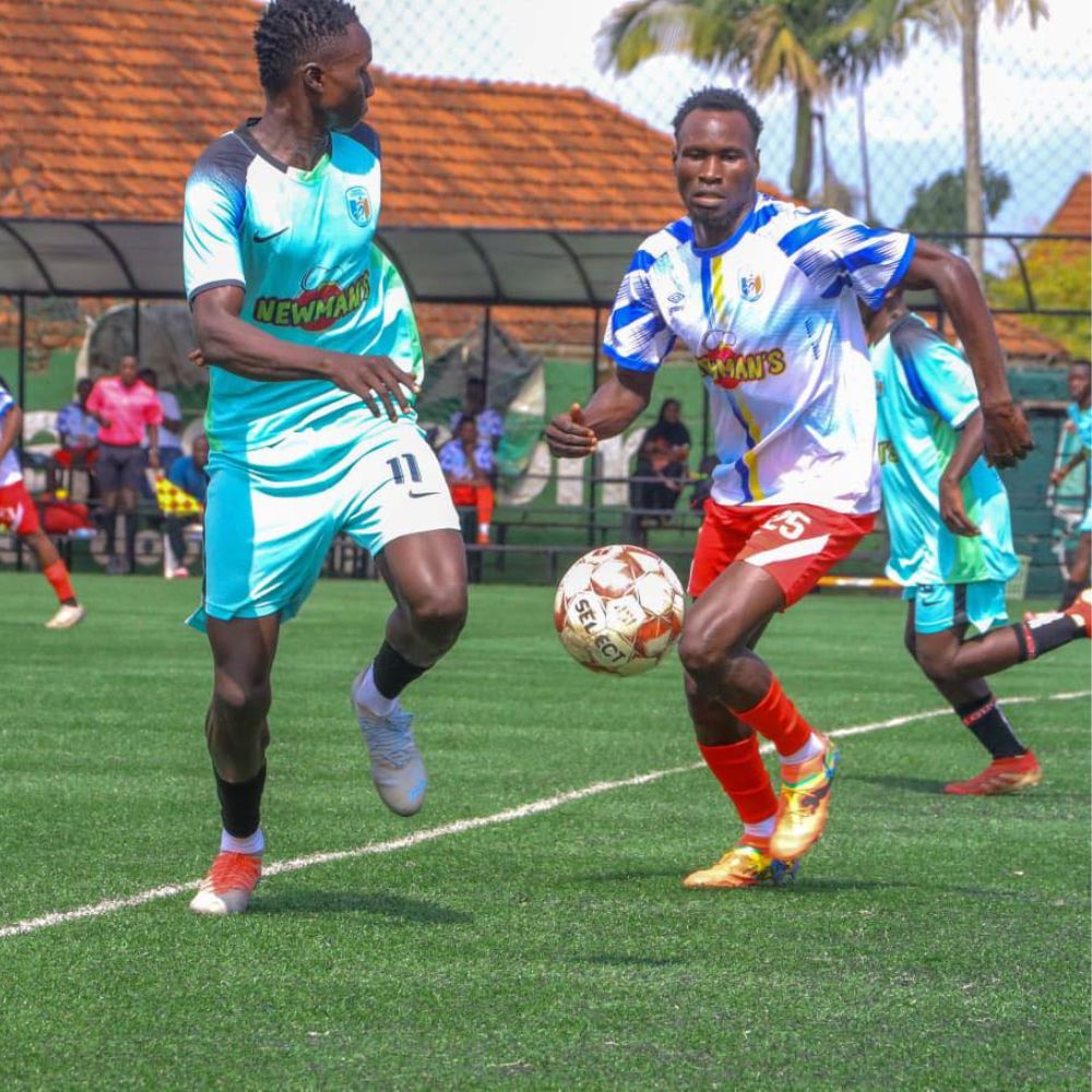 Two football players in action during a match at the Kanta Football Tournament, wearing branded kits sponsored by Newman's.