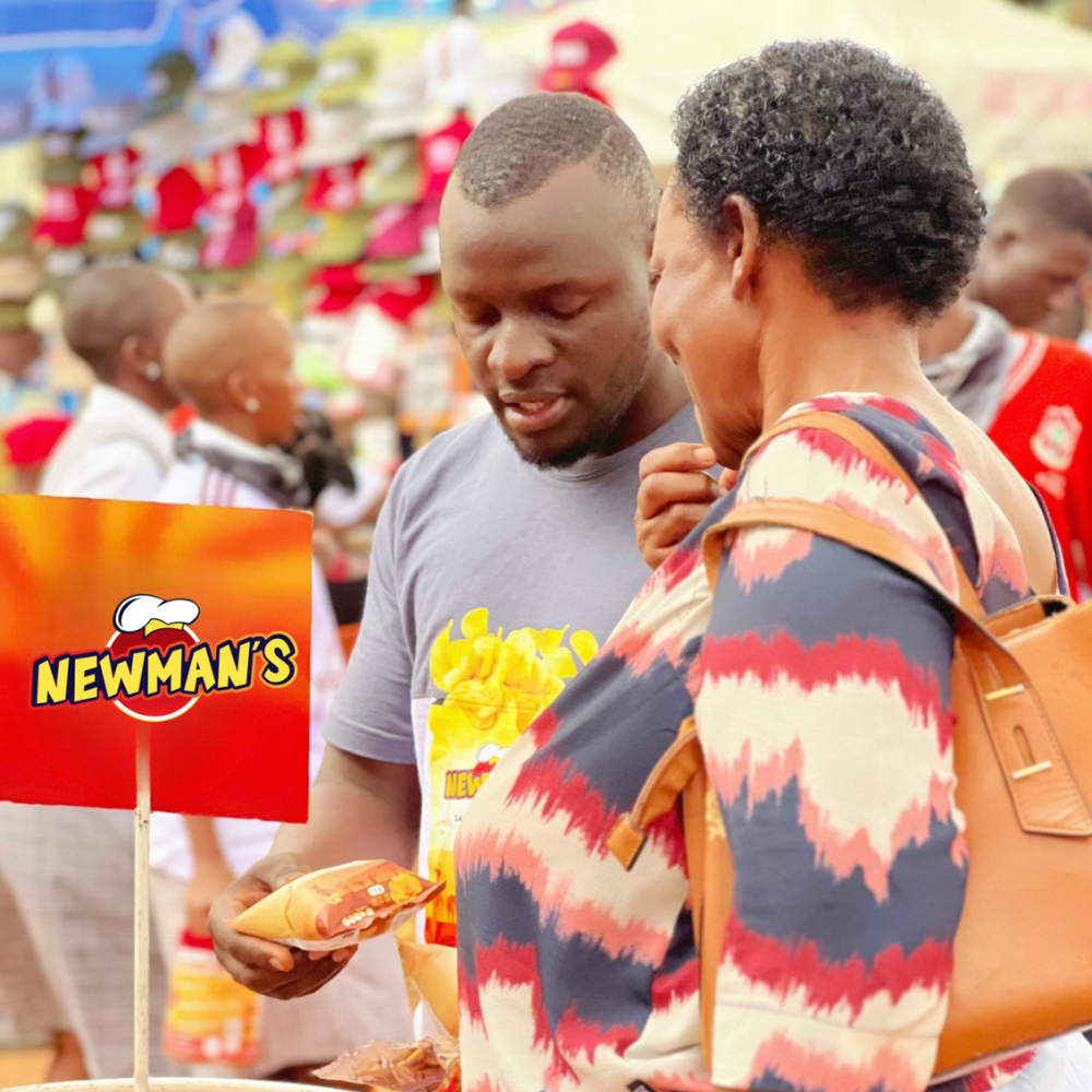 Newman's staff member warmly attending to a customer at a trade fair display